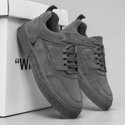 Scarpe sportive da skate grigie a tinta unita con lacci davanti, stile minimalista con punta tonda e suola spessa, scarpe atletiche con suola rialzata